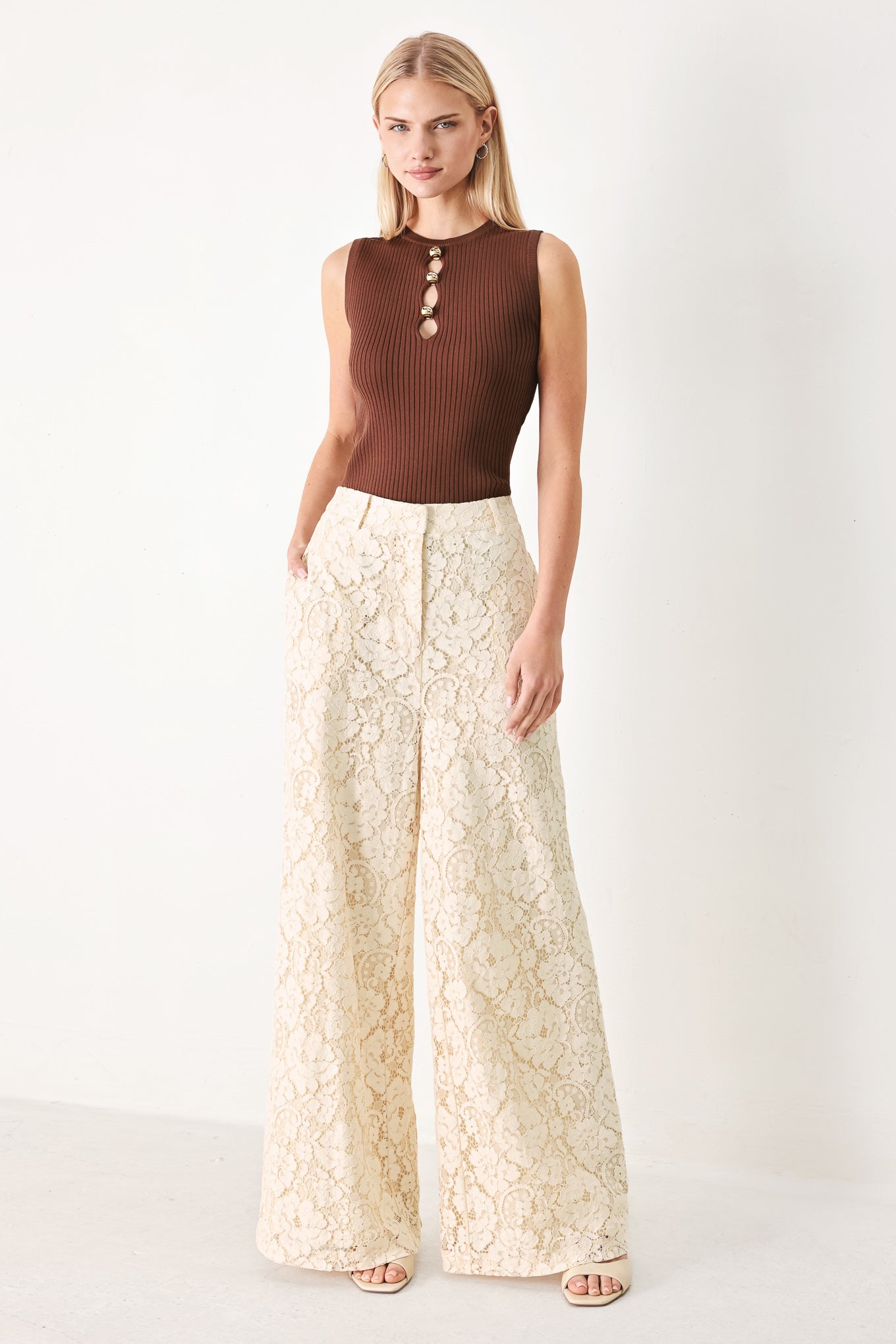 Woman wearing a brown ribbed sleeveless top with a cutout design | FREEMARKET
