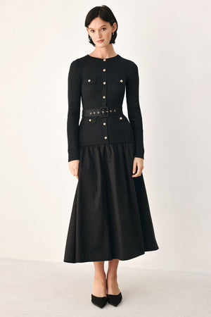 A model wearing a black long-sleeve midi dress with gold-tone decorative buttons down the front, a matching black belt with gold studs, and a flared drop-waist skirt | FREEMARKET