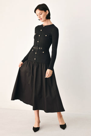 A model wearing a black long-sleeve midi dress with gold-tone decorative buttons down the front, a matching black belt with gold studs, and a flared drop-waist skirt | FREEMARKET