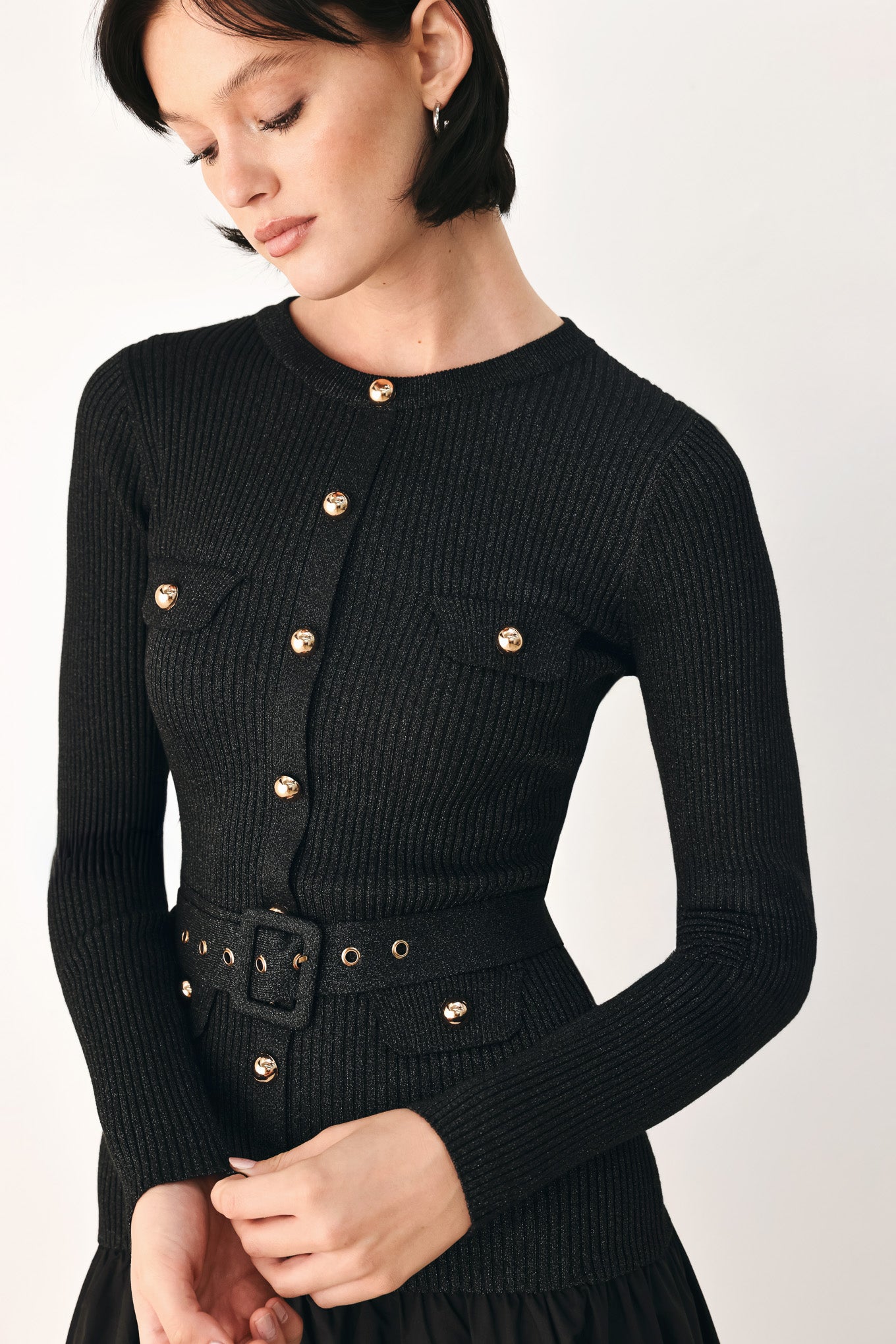 A model wearing a black long-sleeve midi dress with gold-tone decorative buttons down the front, a matching black belt with gold studs, and a flared drop-waist skirt | FREEMARKET