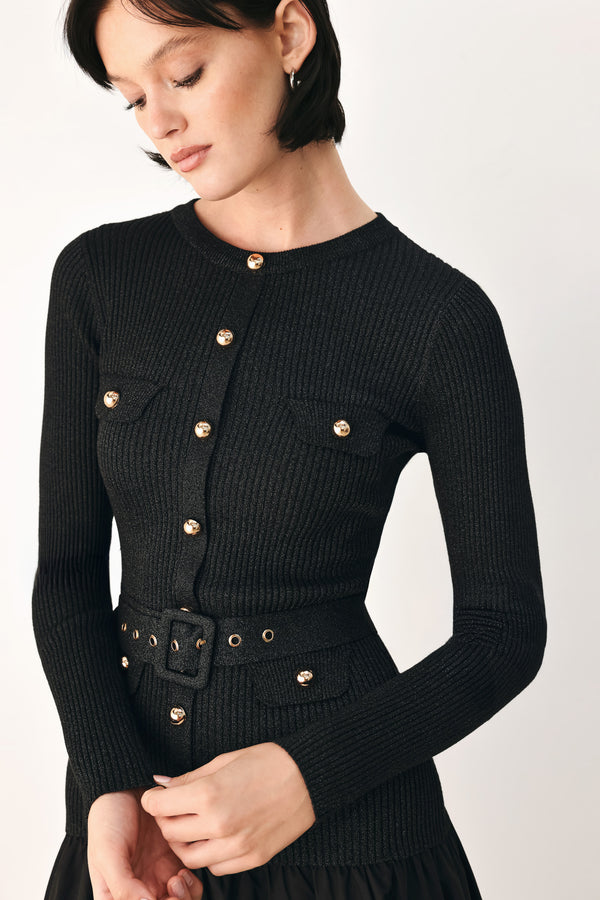 A model wearing a black long-sleeve midi dress with gold-tone decorative buttons down the front, a matching black belt with gold studs, and a flared drop-waist skirt | FREEMARKET
