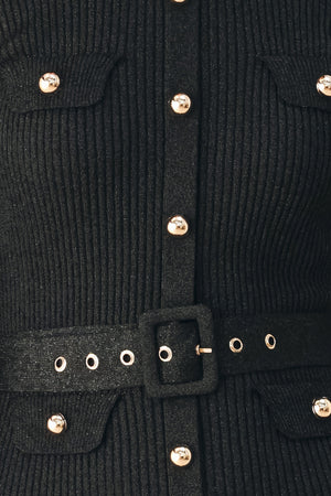 A model wearing a black long-sleeve midi dress with gold-tone decorative buttons down the front, a matching black belt with gold studs, and a flared drop-waist skirt | FREEMARKET