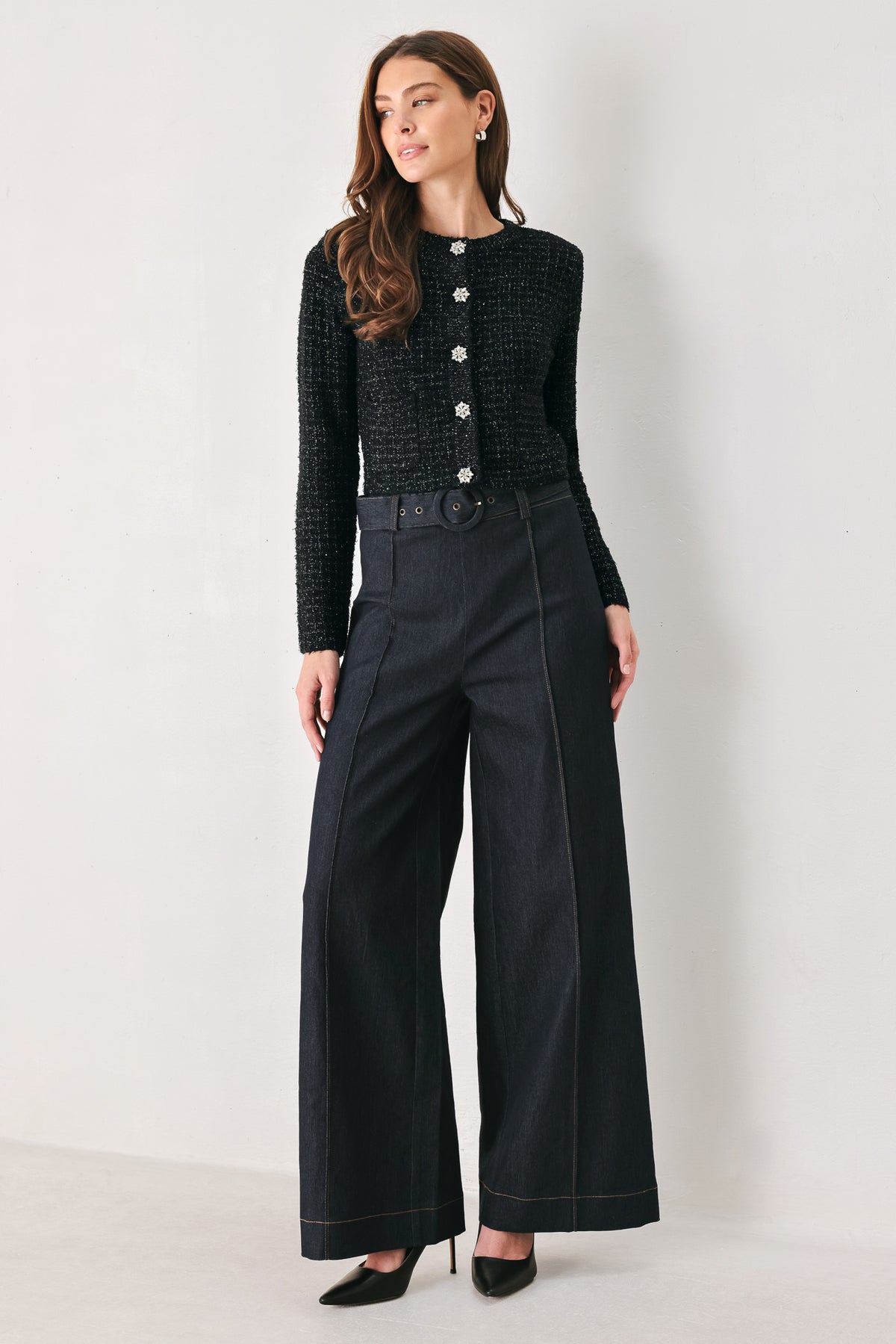 Woman wearing a black long sleeve tweed cardigan with embellished snowflake buttons | FREEMARKET 