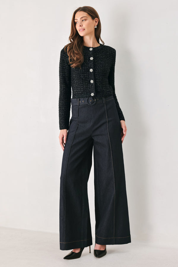 Woman wearing a black long sleeve tweed cardigan with embellished snowflake buttons | FREEMARKET 