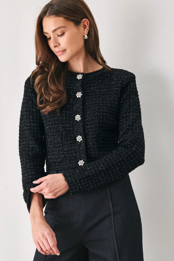 Woman wearing a black long sleeve tweed cardigan with embellished snowflake buttons | FREEMARKET 