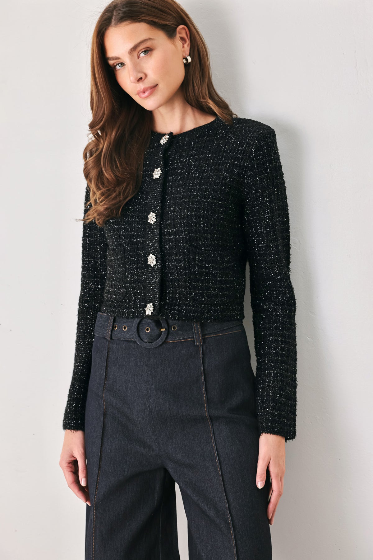 Woman wearing a black long sleeve tweed cardigan with embellished snowflake buttons | FREEMARKET 