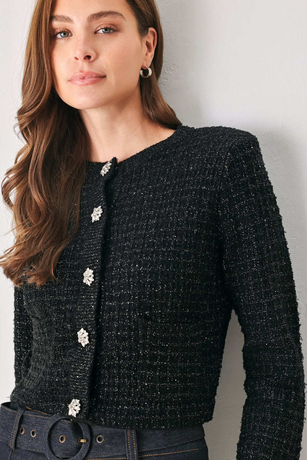 Woman wearing a black long sleeve tweed cardigan with embellished snowflake buttons | FREEMARKET 