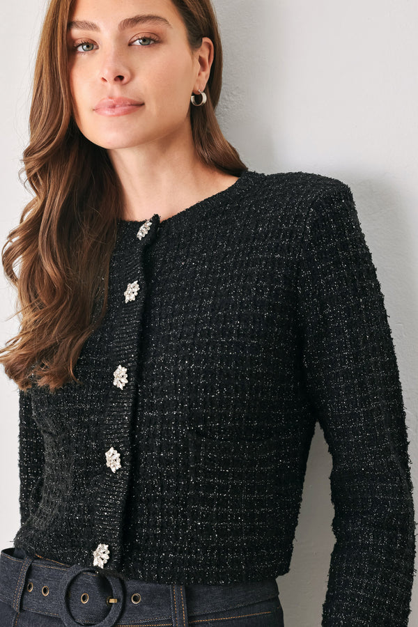 Woman wearing a black long sleeve tweed cardigan with embellished snowflake buttons | FREEMARKET 