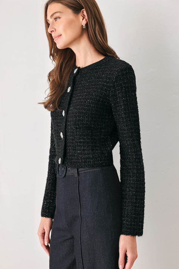 Woman wearing a black long sleeve tweed cardigan with embellished snowflake buttons | FREEMARKET 