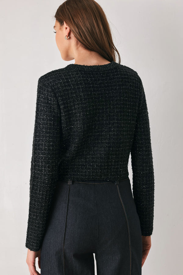 Woman wearing a black long sleeve tweed cardigan with embellished snowflake buttons | FREEMARKET 