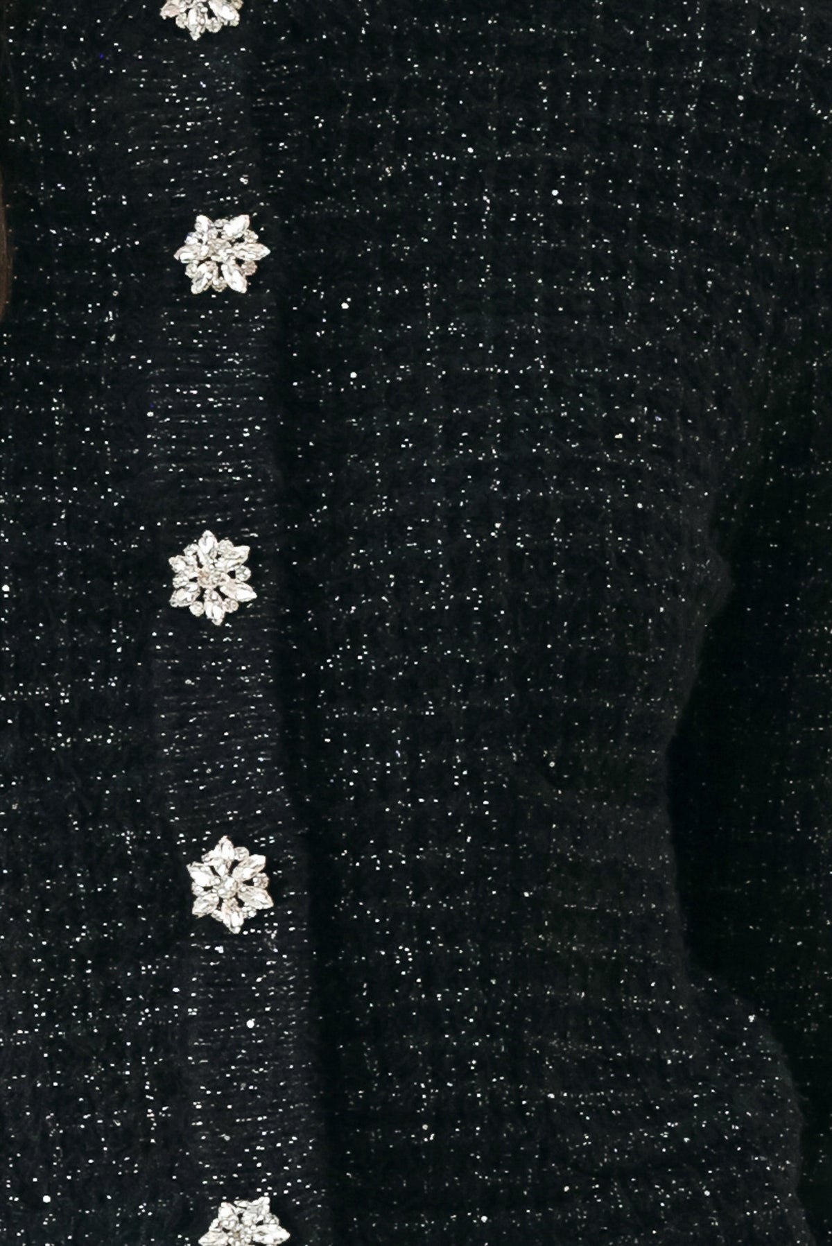 Woman wearing a black long sleeve tweed cardigan with embellished snowflake buttons | FREEMARKET 
