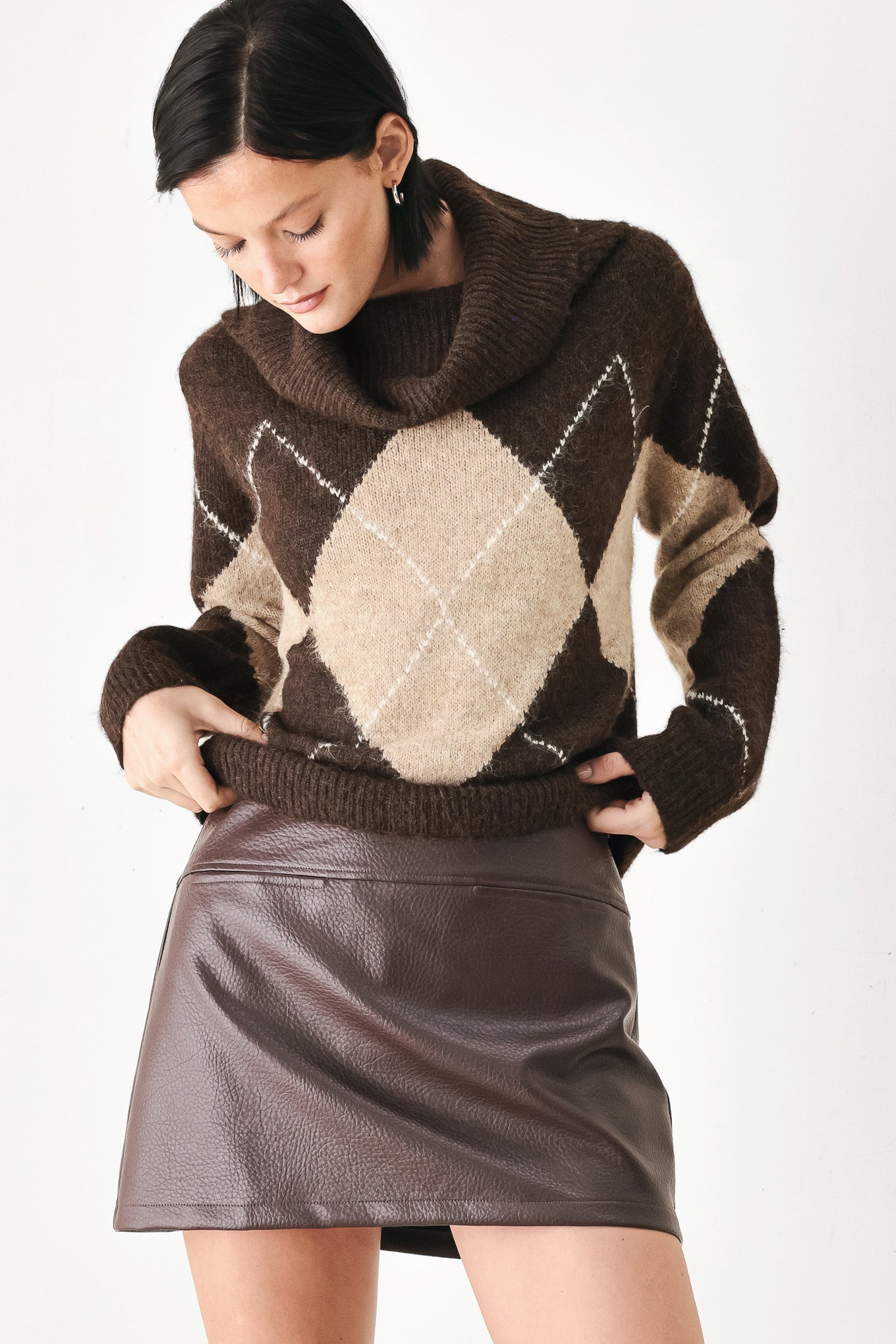 A woman wearing a brown and beige argyle knit sweater with a high folded collar | FREEMARKET