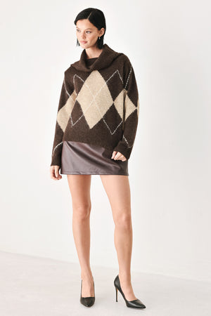 A woman wearing a brown and beige argyle knit sweater with a high folded collar | FREEMARKET