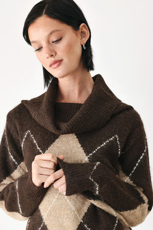 A woman wearing a brown and beige argyle knit sweater with a high folded collar | FREEMARKET