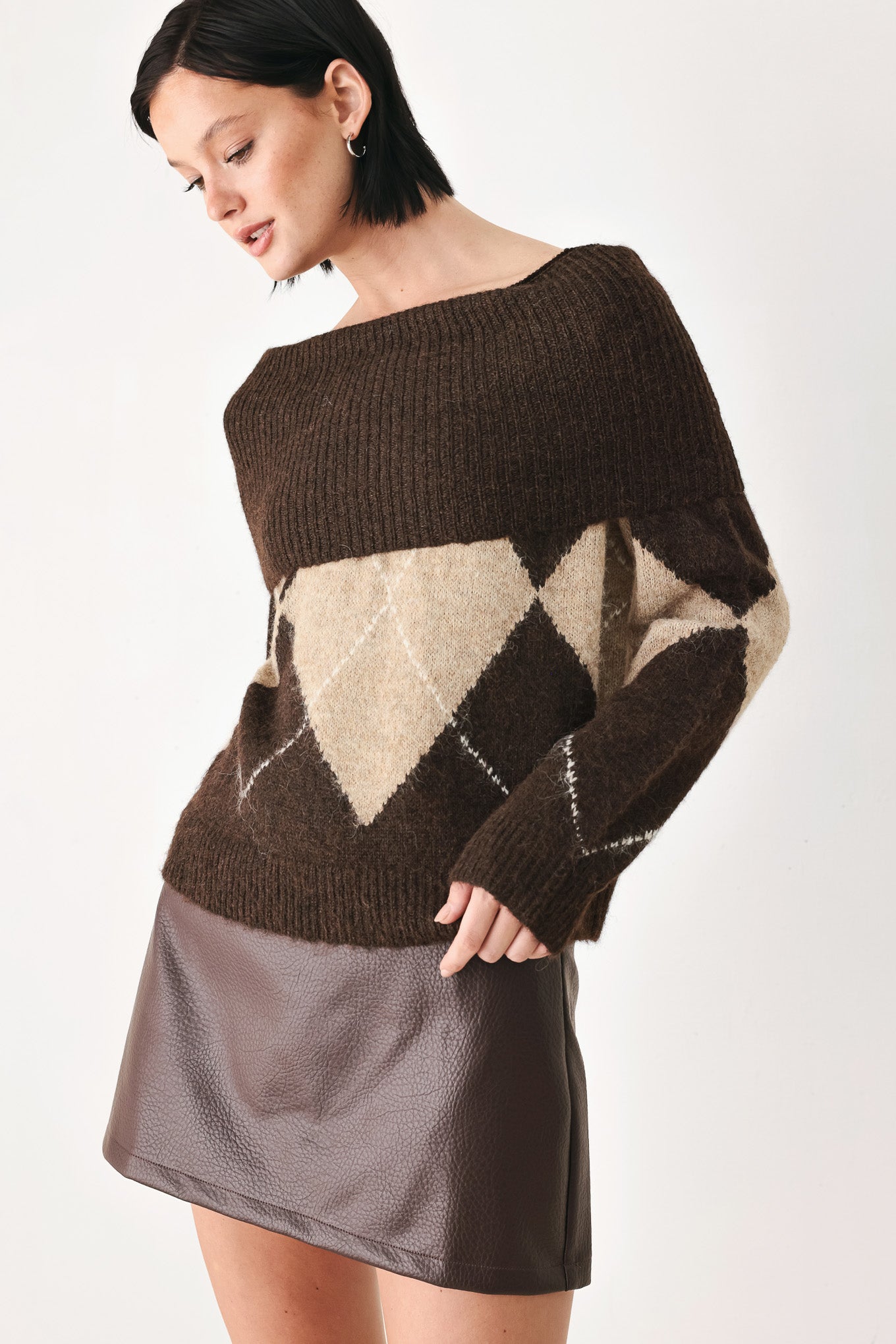 A woman wearing a brown and beige argyle knit sweater with a high folded collar | FREEMARKET