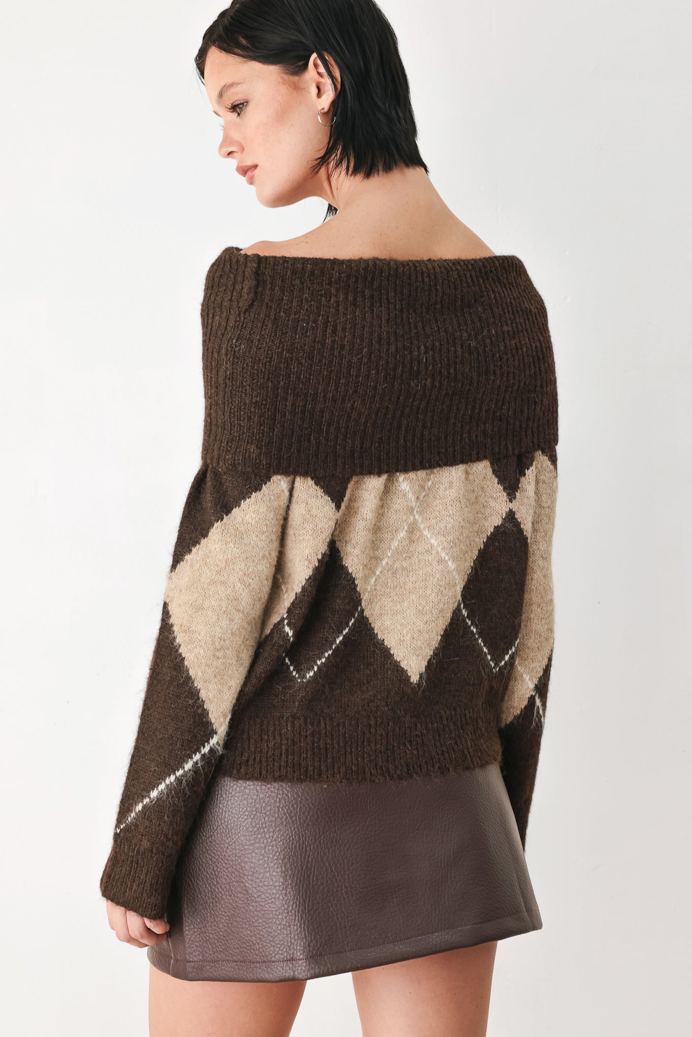 A woman wearing a brown and beige argyle knit sweater with a high folded collar | FREEMARKET