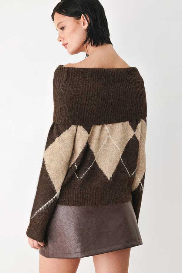 A woman wearing a brown and beige argyle knit sweater with a high folded collar | FREEMARKET