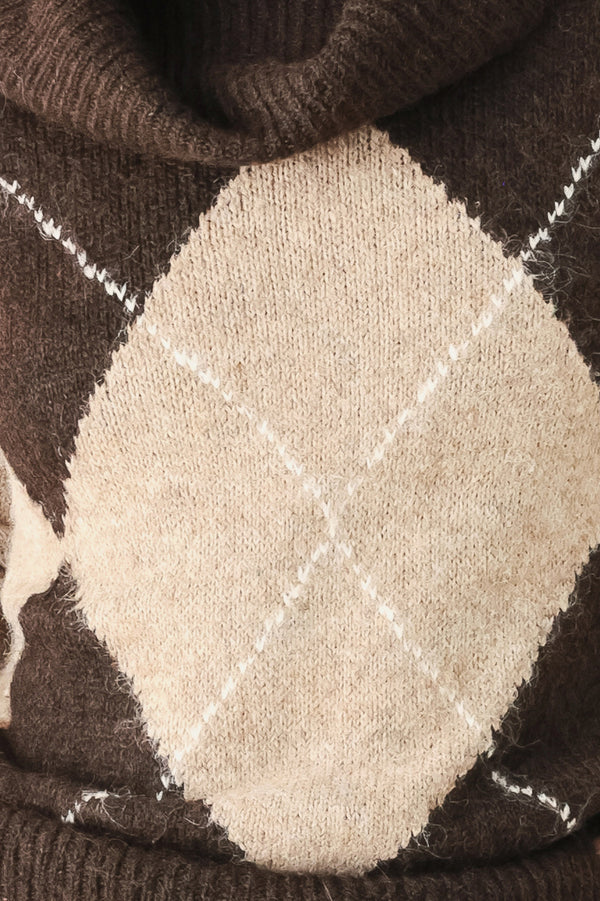 A woman wearing a brown and beige argyle knit sweater with a high folded collar | FREEMARKET