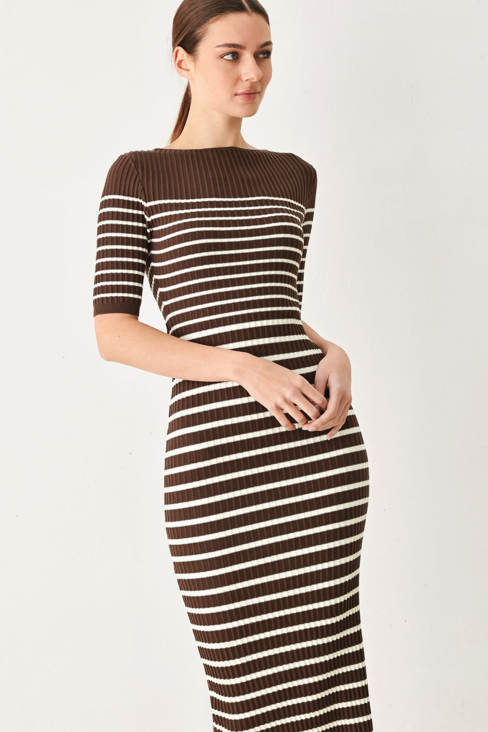 Woman wearing a brown and white horizontal stripped ribbed sweater knit midi dress | FREEMARKET
