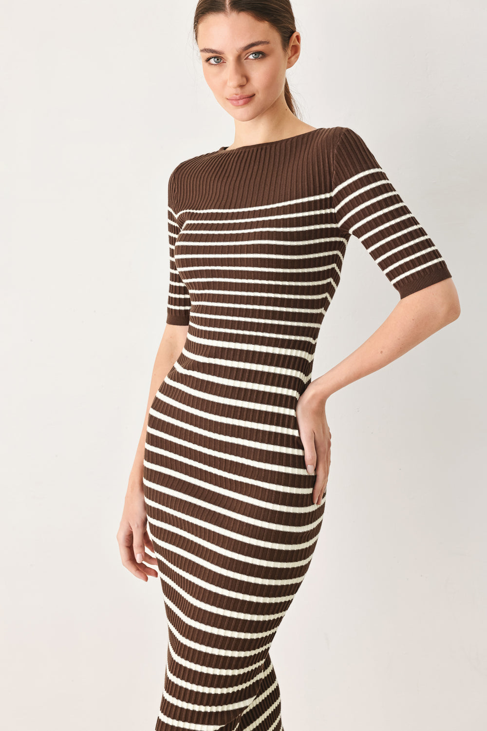 Woman wearing a brown and white horizontal stripped ribbed sweater knit midi dress | FREEMARKET