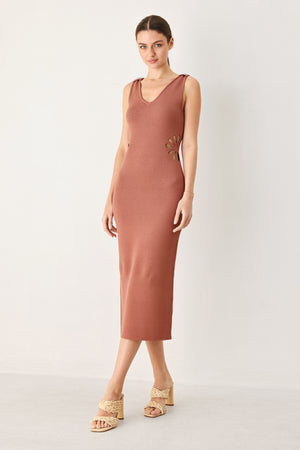 Woman wearing a clay colored sweater knit midi dress featuring V neckline and side cut out in a flower shape | FREEMARKET