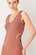 Woman wearing a clay colored sweater knit midi dress featuring V neckline and side cut out in a flower shape | FREEMARKET