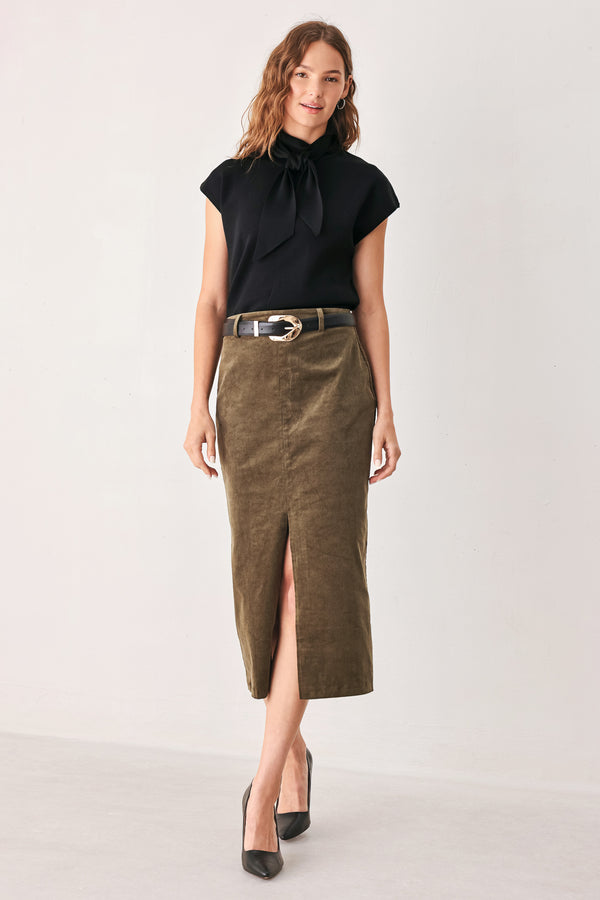 A woman wearing a black short-sleeve knit top with a high mock neck and a large draped tie detail at the front | FREEMARKET