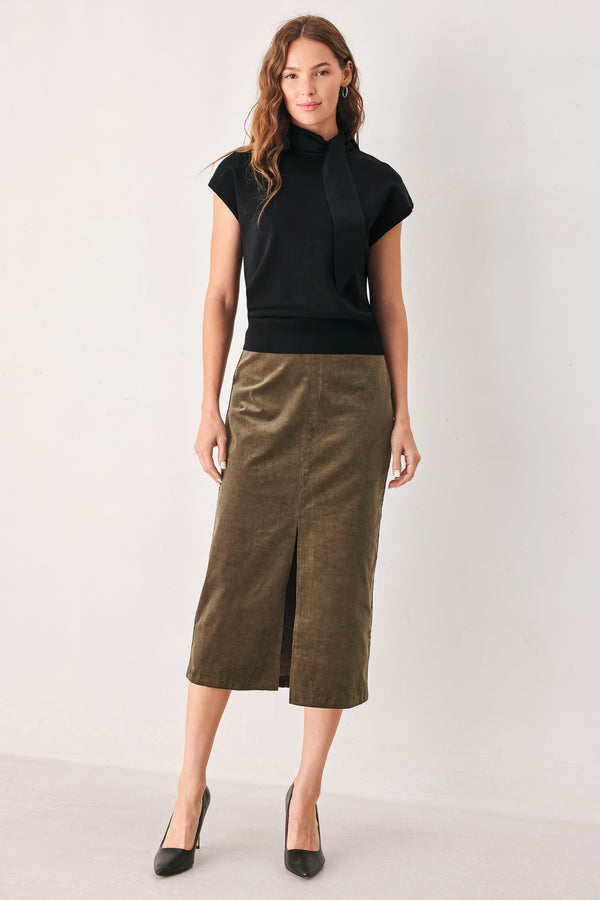 A woman wearing a black short-sleeve knit top with a high mock neck and a large draped tie detail at the front | FREEMARKET