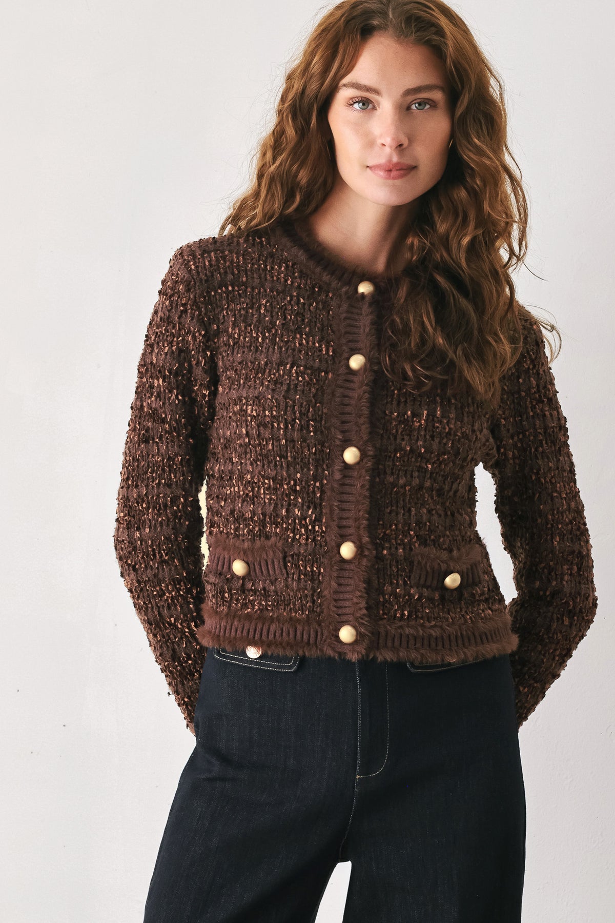 Woman wearing a brown knitted cardigan top with dome shaped gold buttons | FREEMARKET