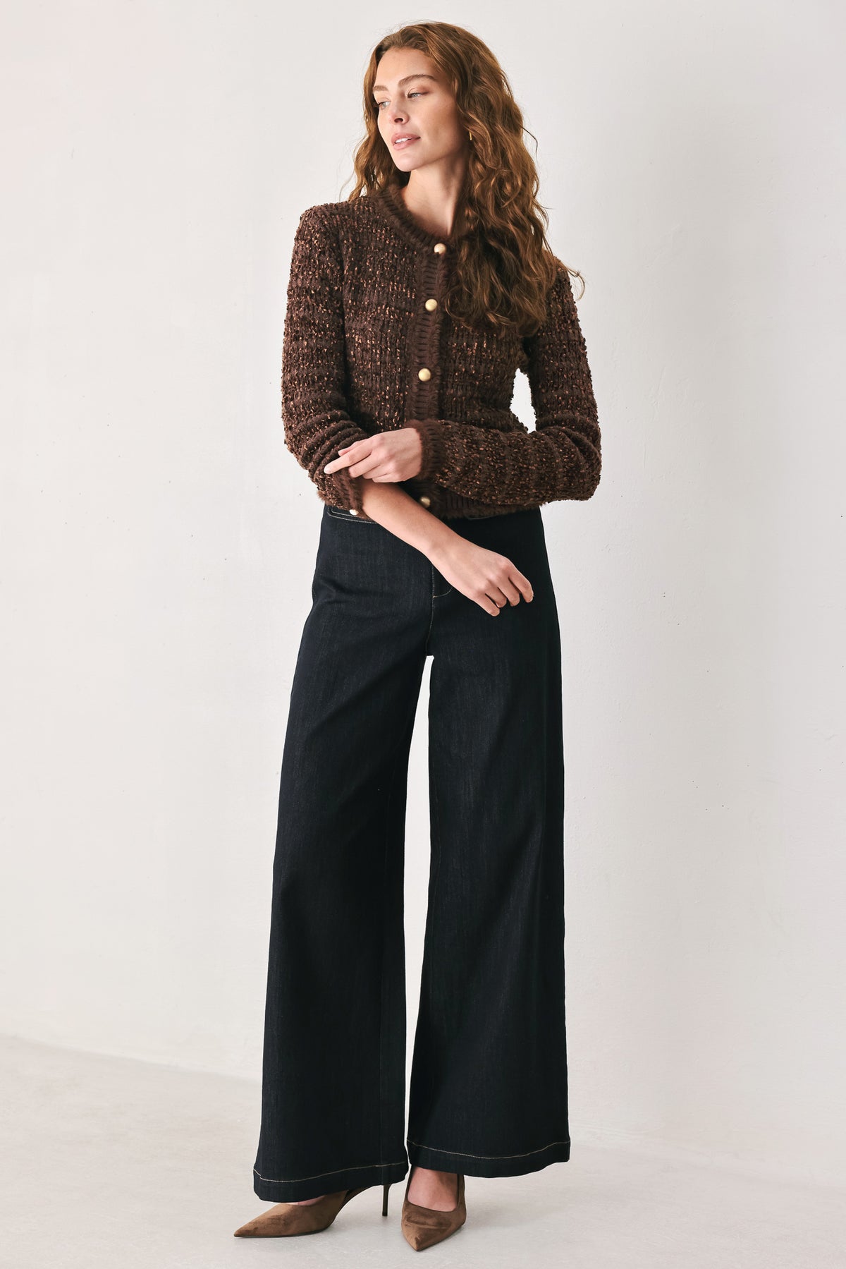 Woman wearing a brown knitted cardigan top with dome shaped gold buttons | FREEMARKET