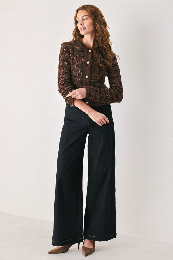 Woman wearing a brown knitted cardigan top with dome shaped gold buttons | FREEMARKET
