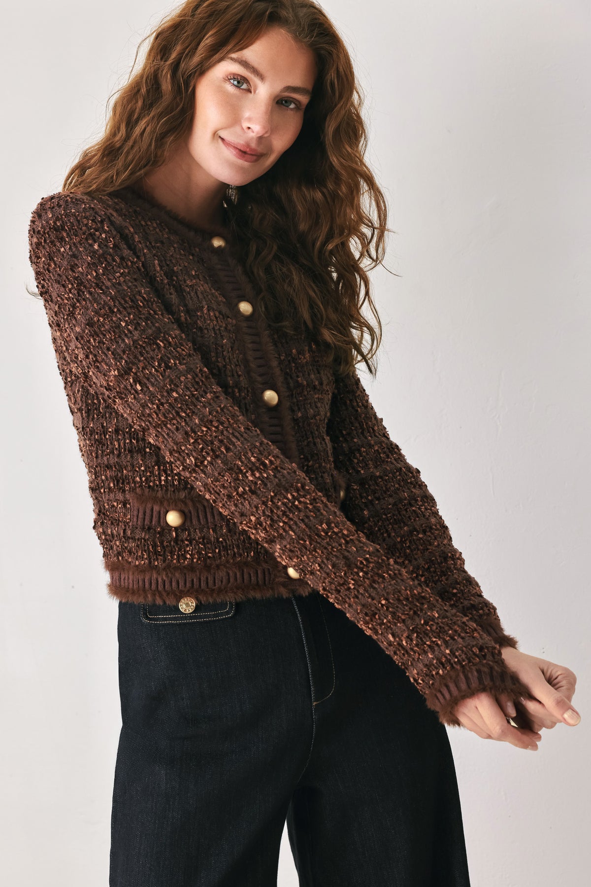 Woman wearing a brown knitted cardigan top with dome shaped gold buttons | FREEMARKET