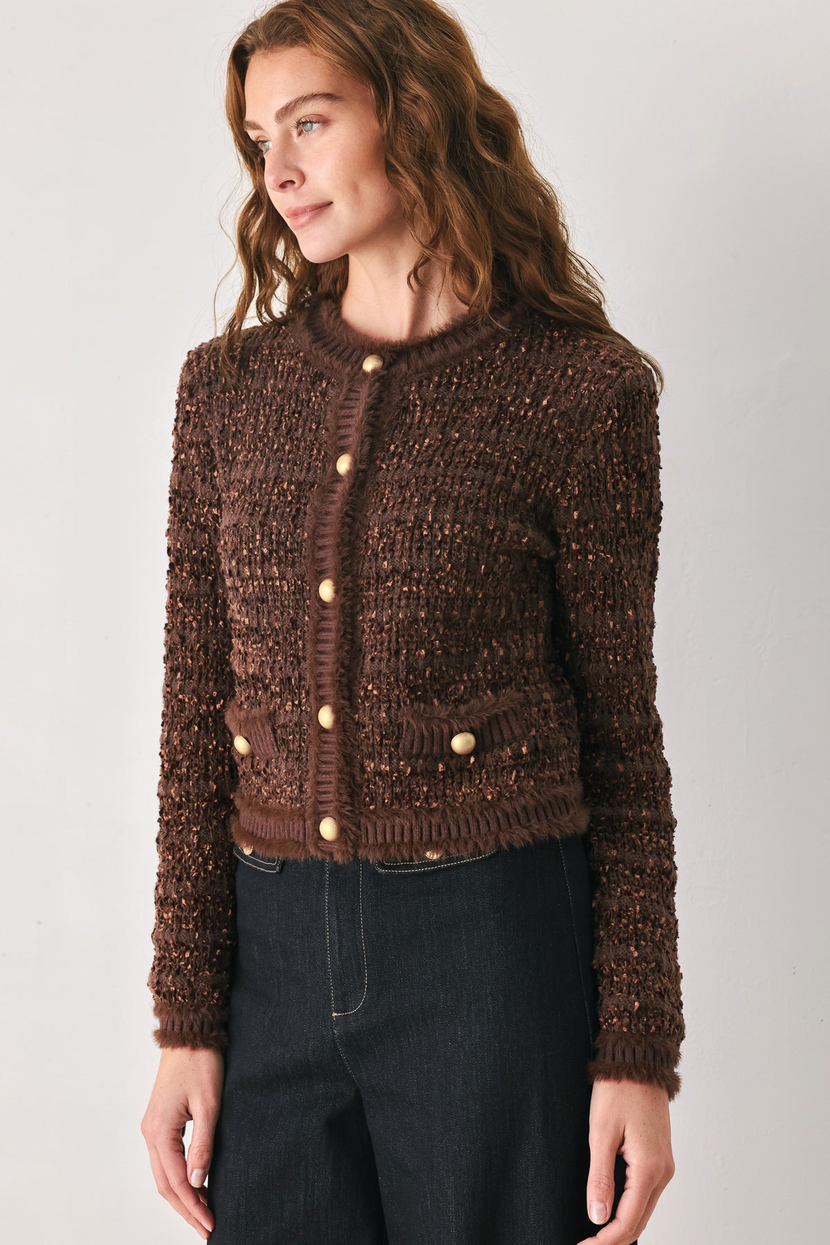 Woman wearing a brown knitted cardigan top with dome shaped gold buttons | FREEMARKET