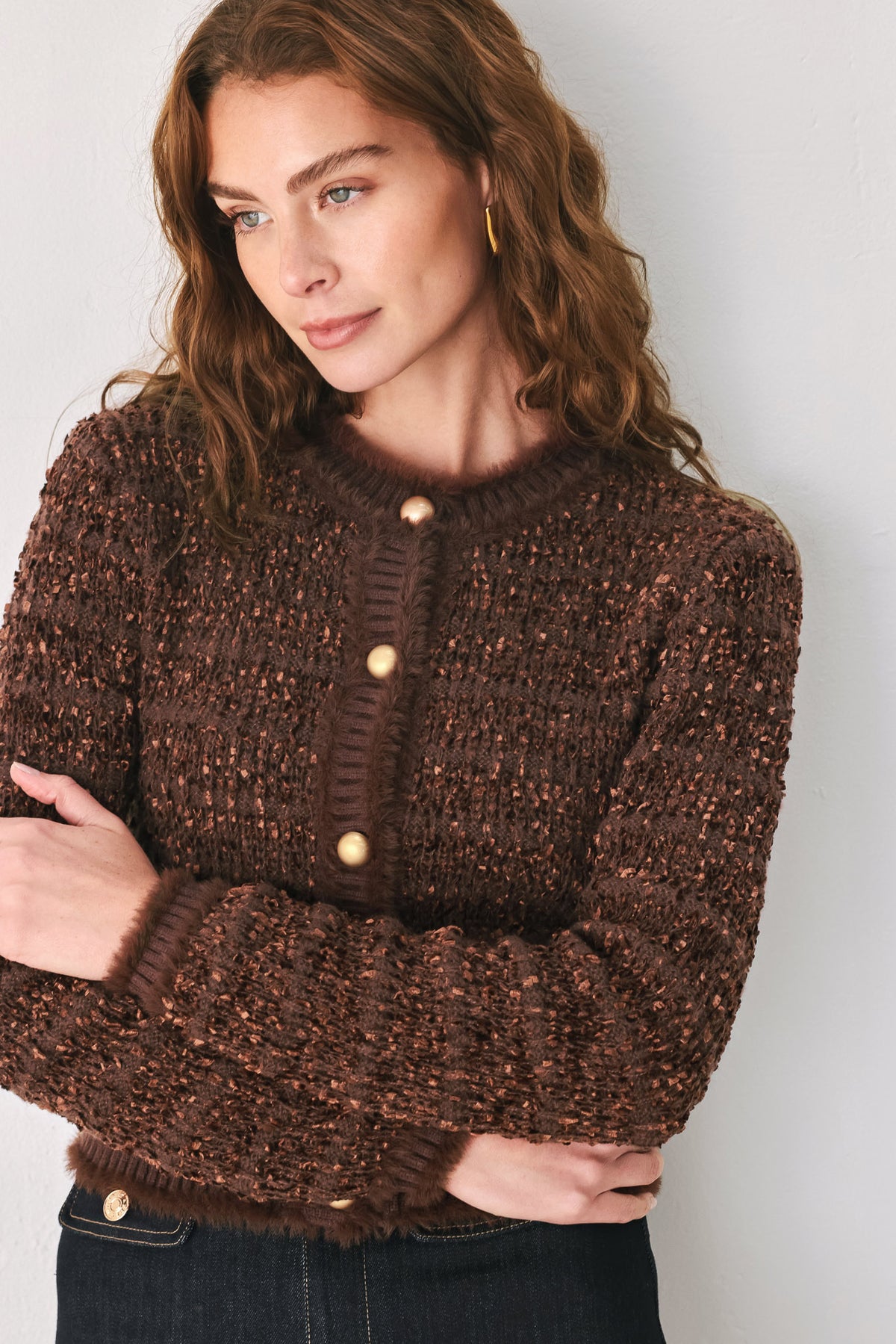 Woman wearing a brown knitted cardigan top with dome shaped gold buttons | FREEMARKET