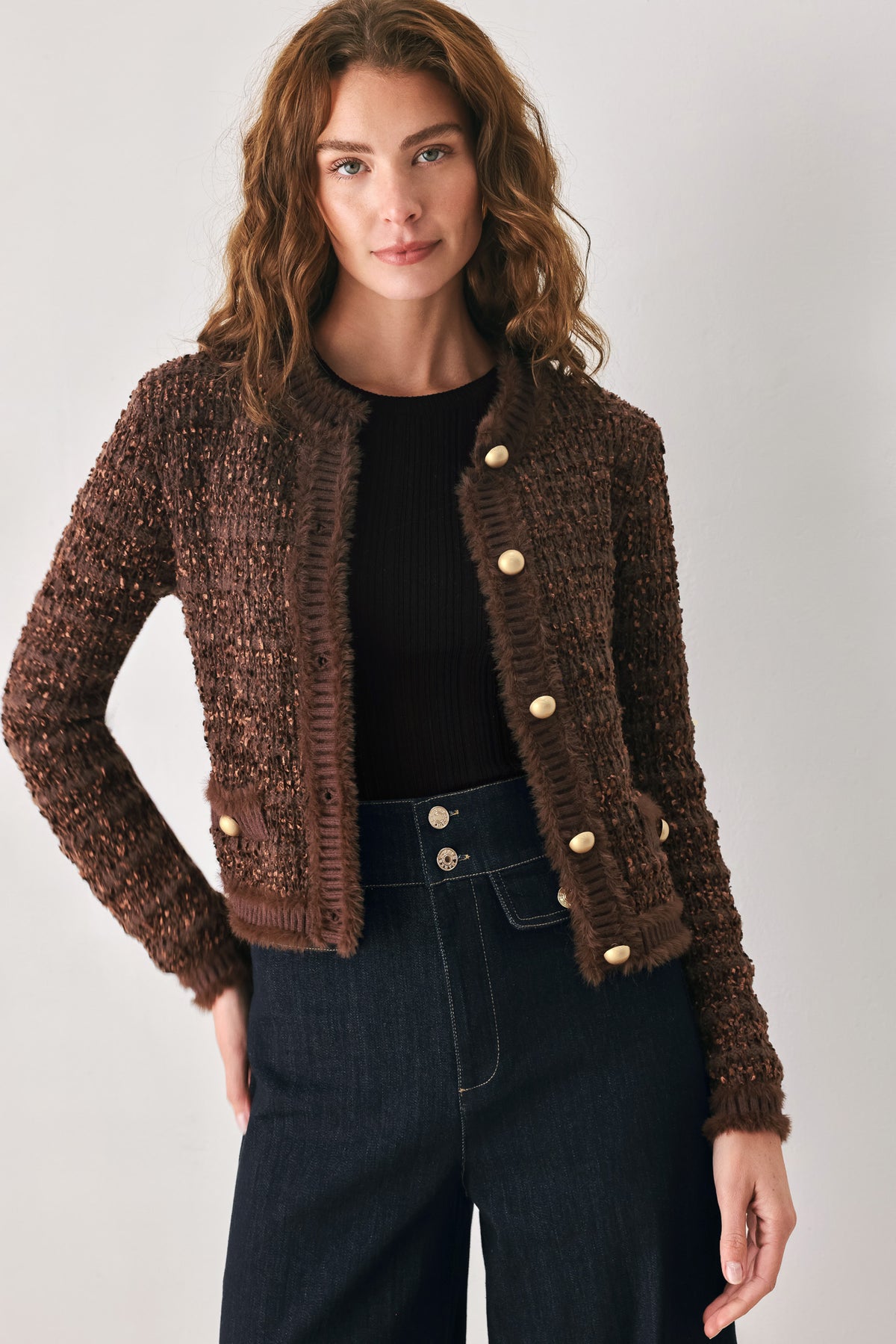 Woman wearing a brown knitted cardigan top with dome shaped gold buttons | FREEMARKET