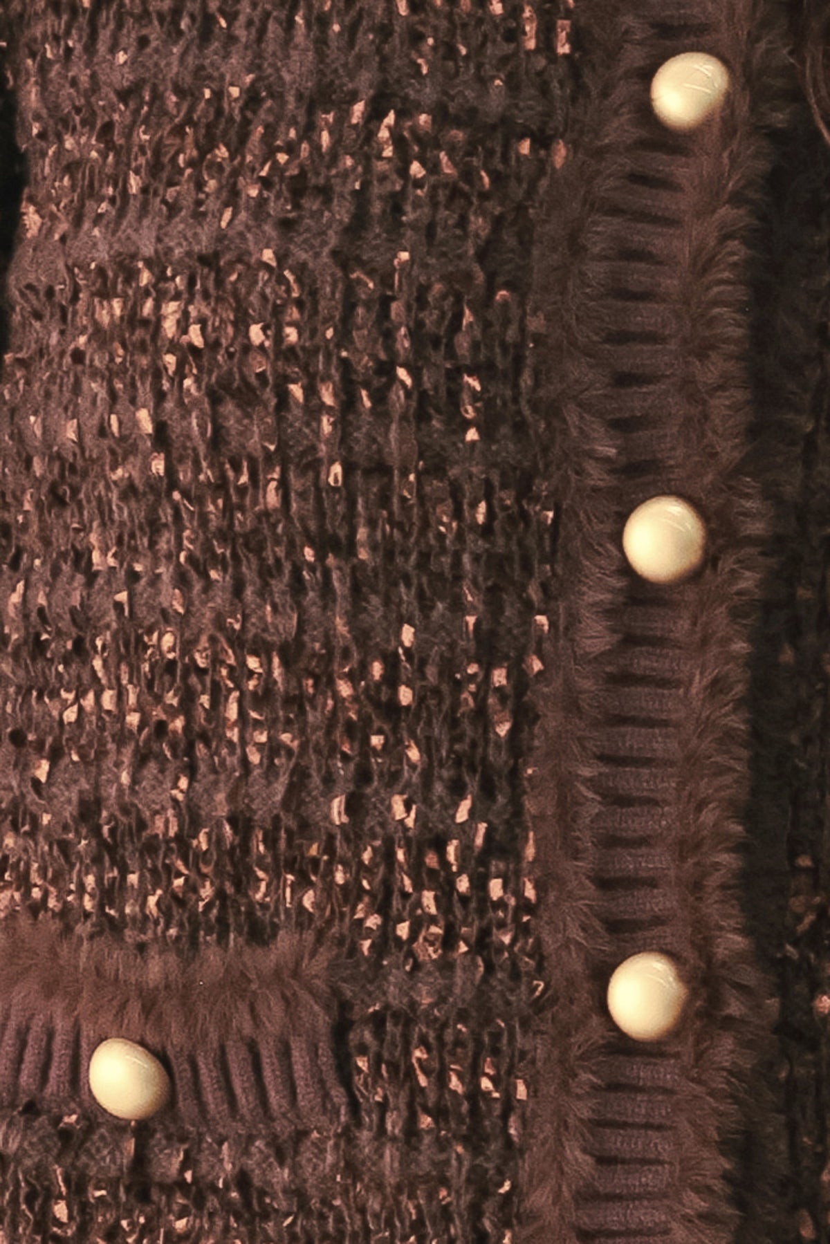 Woman wearing a brown knitted cardigan top with dome shaped gold buttons | FREEMARKET
