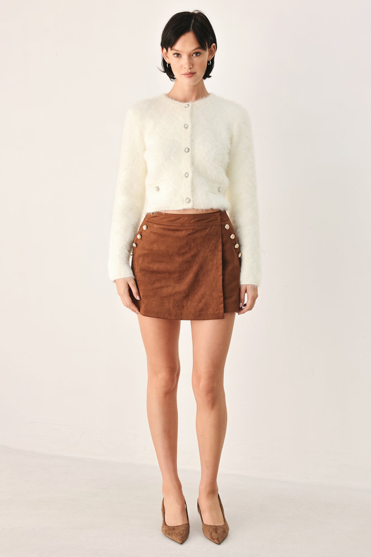 A model wearing an ivory fuzzy cropped cardigan with buttons | FREEMARKET