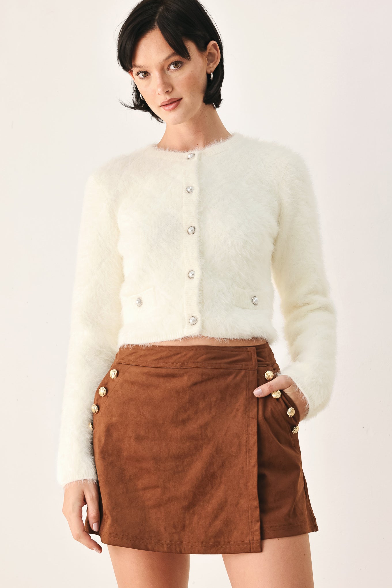 A model wearing an ivory fuzzy cropped cardigan with buttons | FREEMARKET