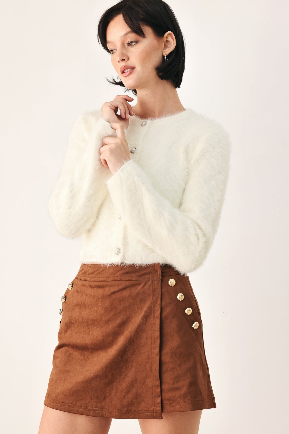 A model wearing an ivory fuzzy cropped cardigan with buttons | FREEMARKET