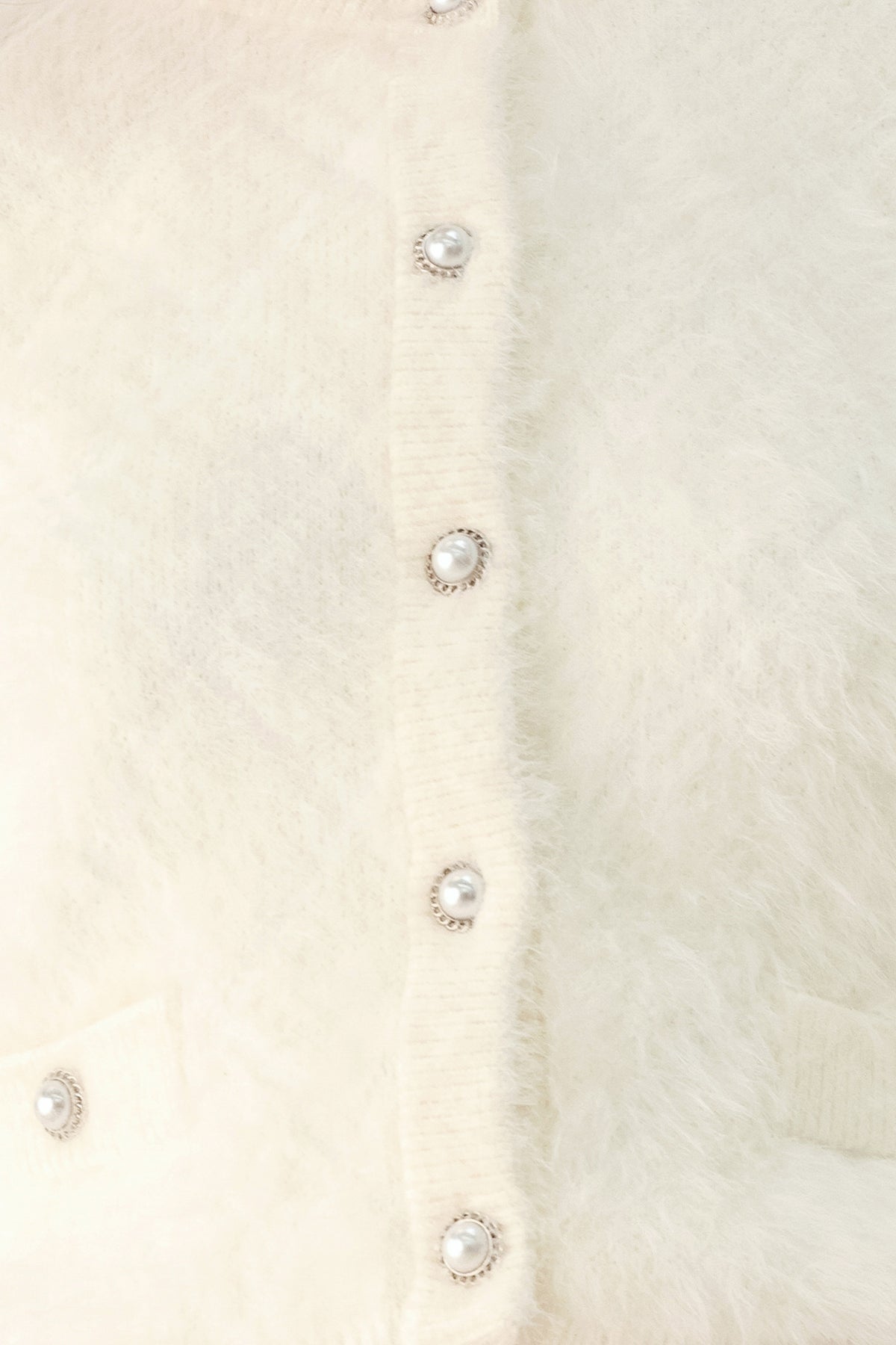 A model wearing an ivory fuzzy cropped cardigan with buttons | FREEMARKET