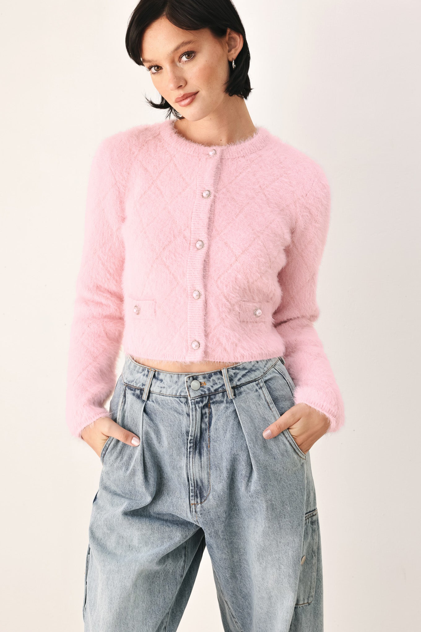 A model wearing a pink fuzzy cropped cardigan with buttons | FREEMARKET