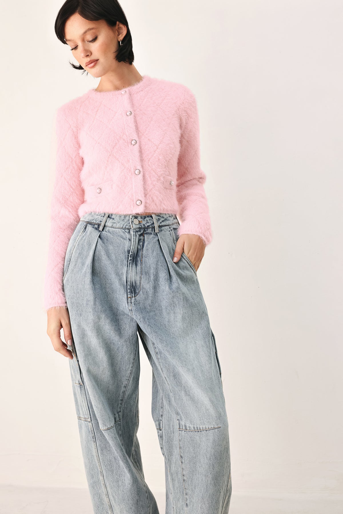 A model wearing a pink fuzzy cropped cardigan with buttons | FREEMARKET