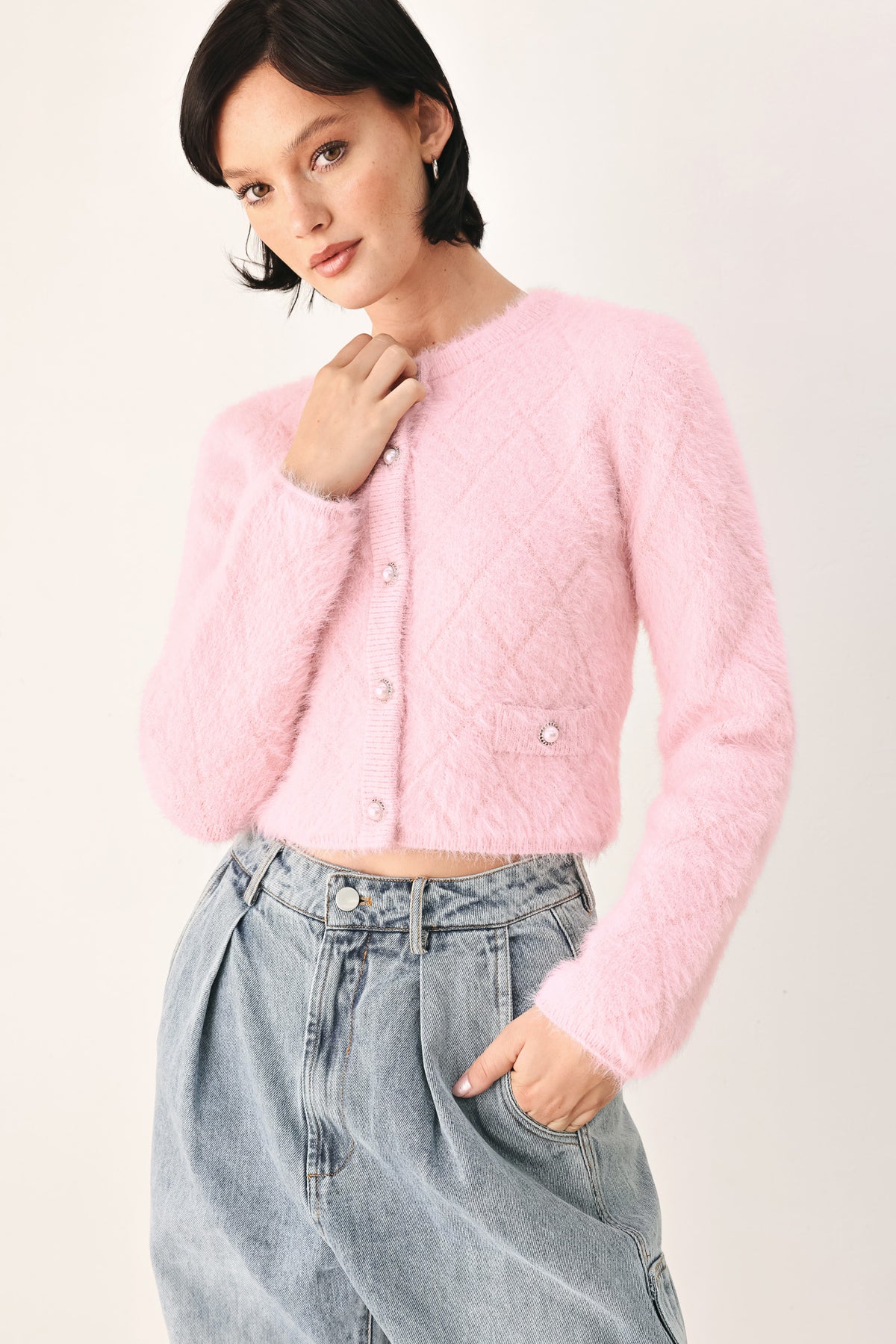A model wearing a pink fuzzy cropped cardigan with buttons | FREEMARKET