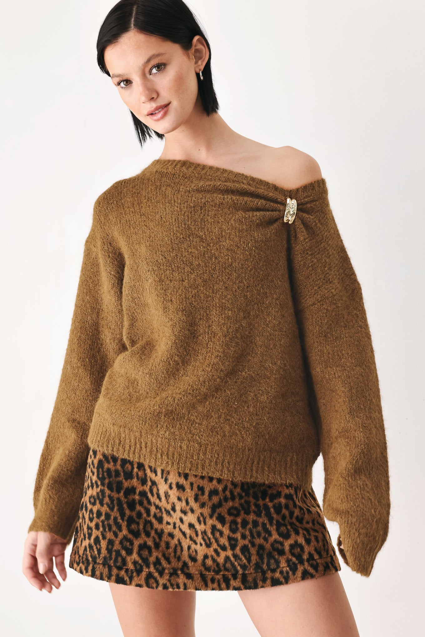 A woman modeling a camel knit sweater with a unique draped neckline and a small gold button accent | FREEMARKET
