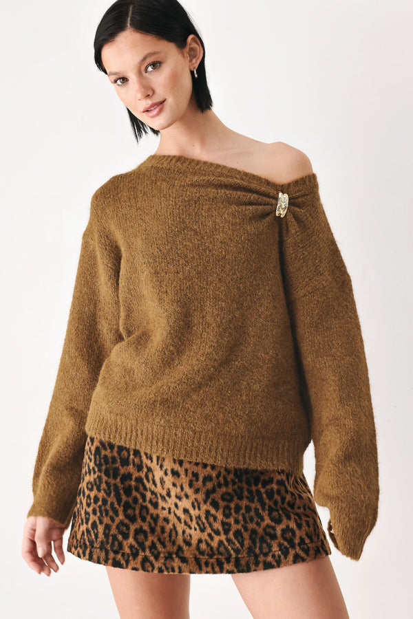 A woman modeling a camel knit sweater with a unique draped neckline and a small gold button accent | FREEMARKET