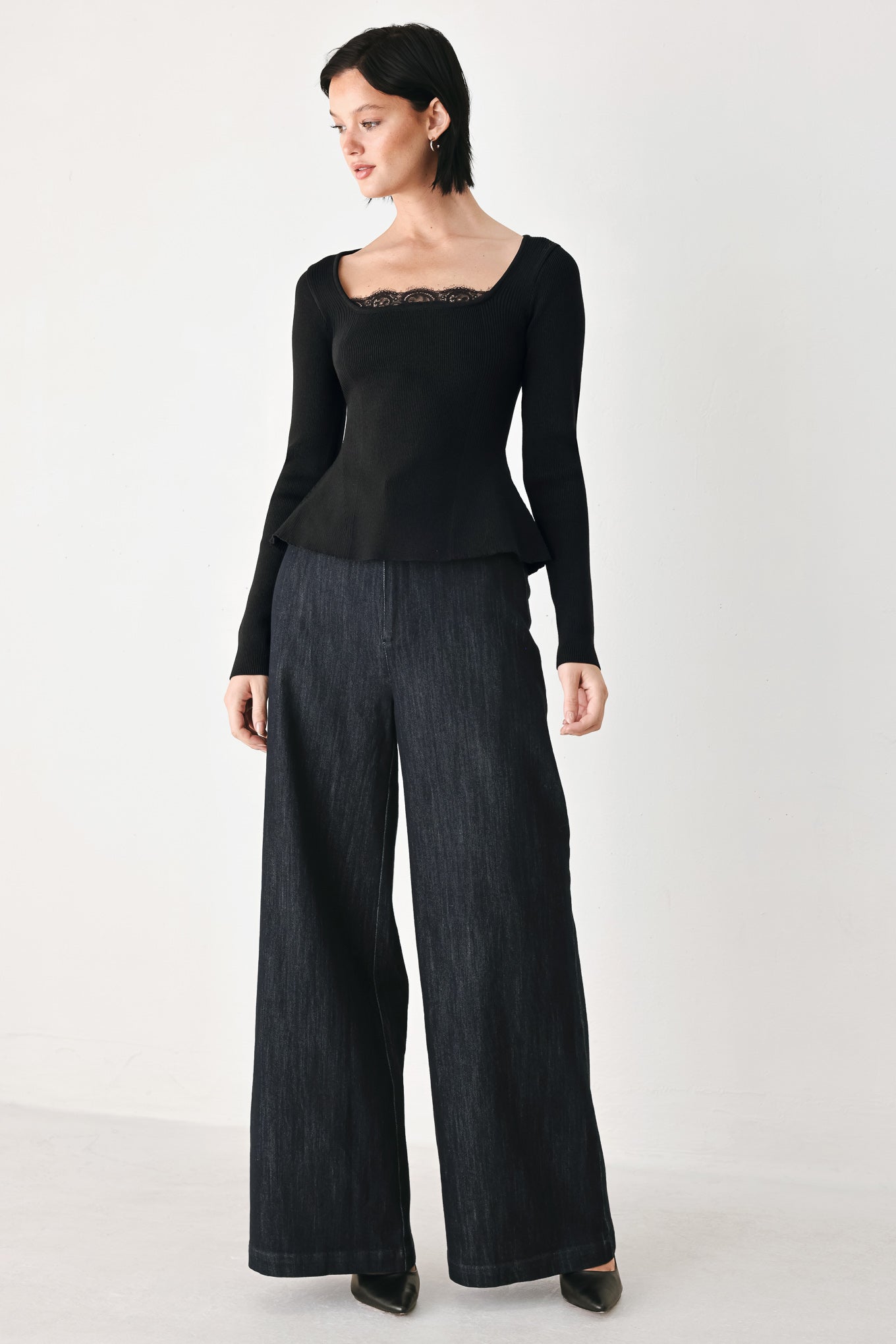 A model wearing a black long-sleeve top with a square neckline and delicate lace trim | FREEMARKET