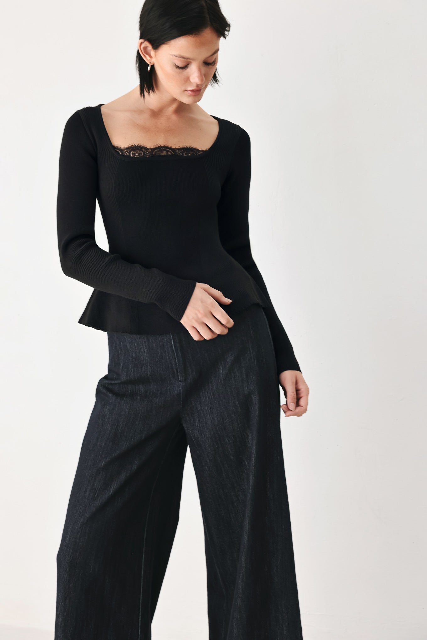 A model wearing a black long-sleeve top with a square neckline and delicate lace trim | FREEMARKET