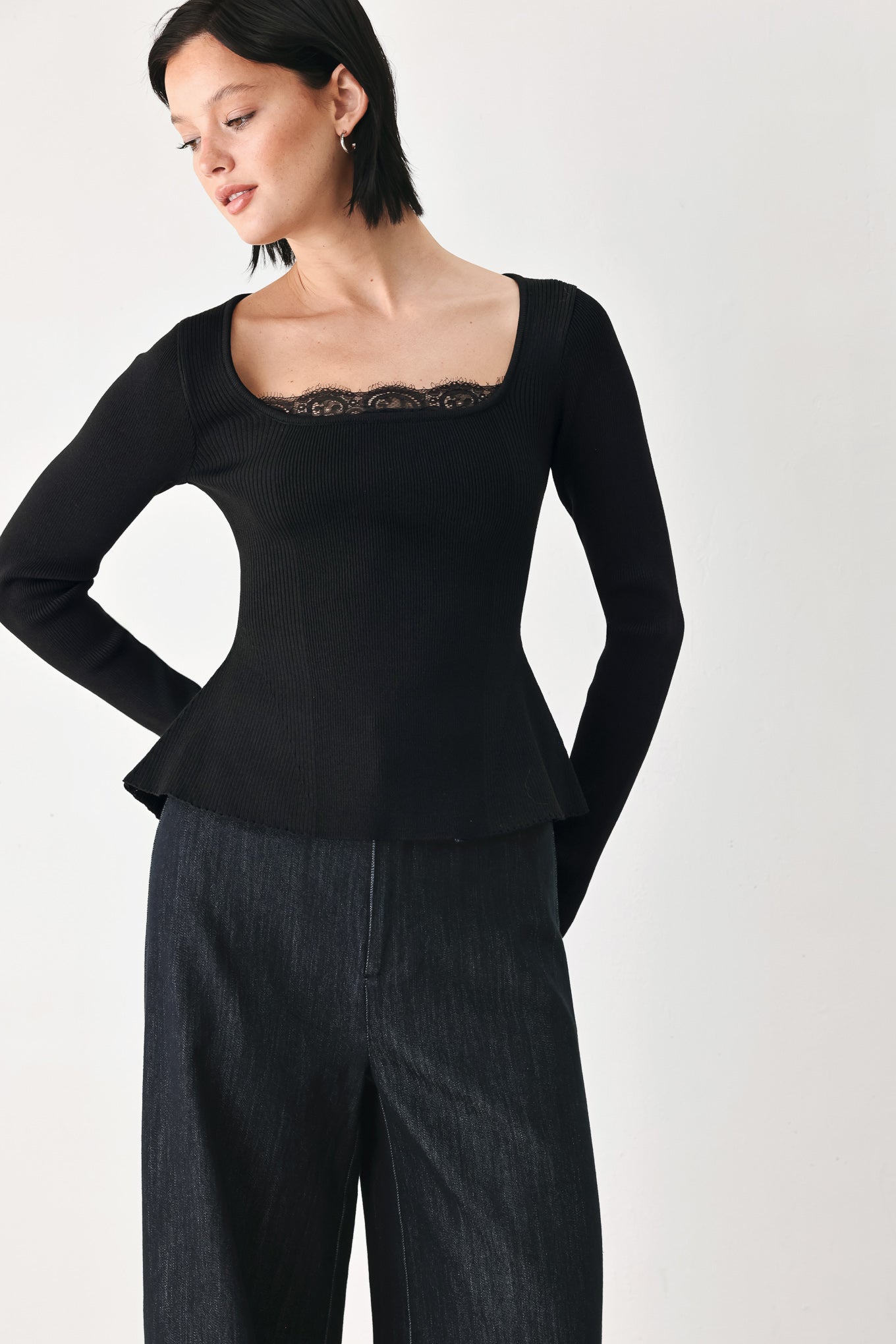 A model wearing a black long-sleeve top with a square neckline and delicate lace trim | FREEMARKET