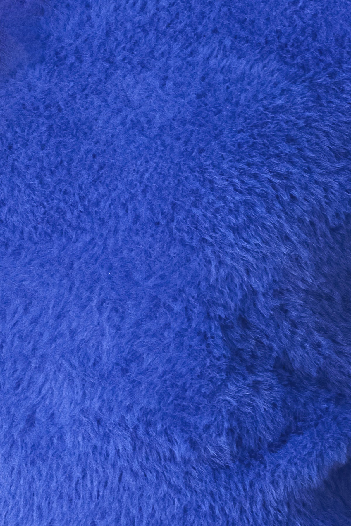A woman wearing a fuzzy cobalt blue long-sleeve knit sweater top | FREEMARKET
