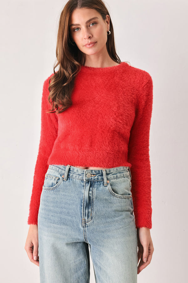 A woman wearing a fuzzy, textured red long-sleeve crop sweater | FREEMARKET